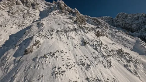 Cinematic FPV Cloud Surfing Fresh Snow Alpine Ridge, 4K Stock Footage 323465517