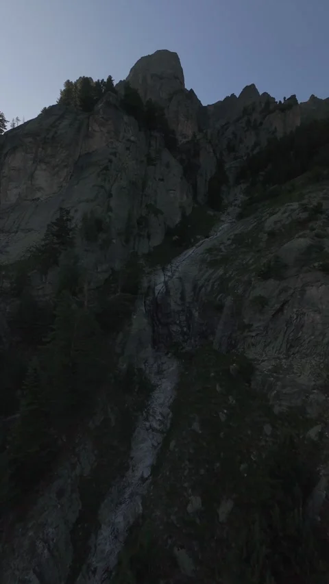 Cinematic FPV drone ascent along steep rocky cliffs at sunset in Rila, Bulgaria. Stock Footage 343418987