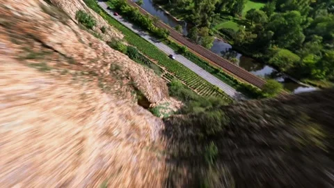 Cinematic FPV Drone Cliff Dive and Low Flight Along Mountain Road Vídeos de archivo 317581227