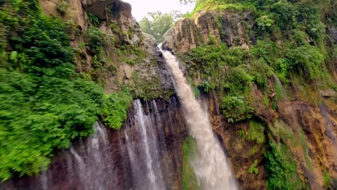 Cinematic FPV drone dive through stunning Tumpak Sewu waterfall in Indonesia Stock Footage 315275557