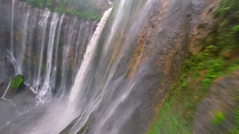 Cinematic FPV drone dive through stunning Tumpak Sewu waterfall in Indonesia Stock Footage 317504568