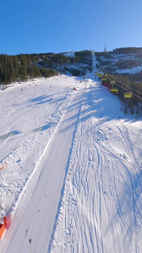 Cinematic FPV drone flight above ski lift and snowy ski slope with skiers 스톡 동영상 337959026