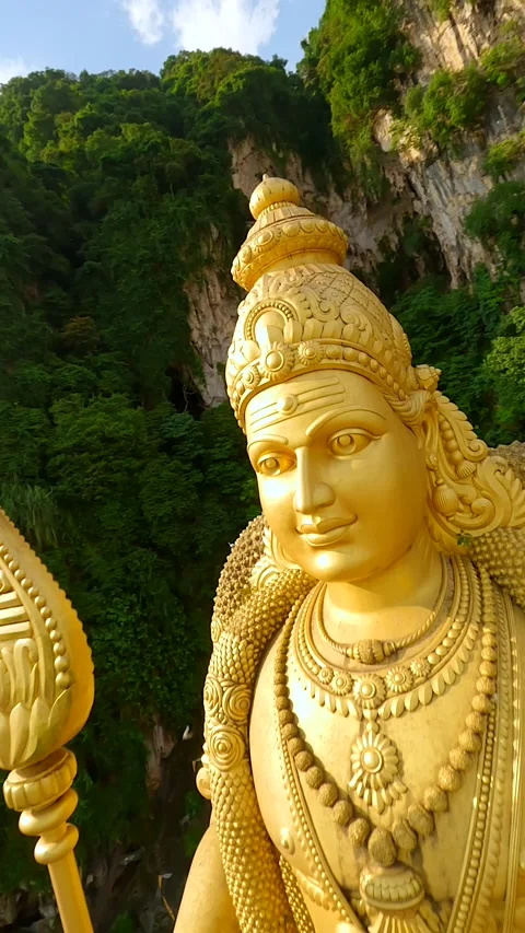 Cinematic FPV drone flight around golden Murugan statue at Batu Caves, Malaysia Stock Footage 310542979