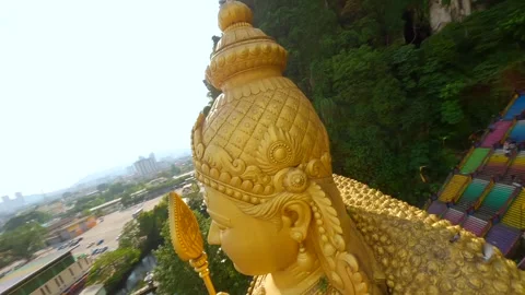 Cinematic FPV drone flight around golden Murugan statue at Batu Caves, Malaysia Stock Footage 310543002