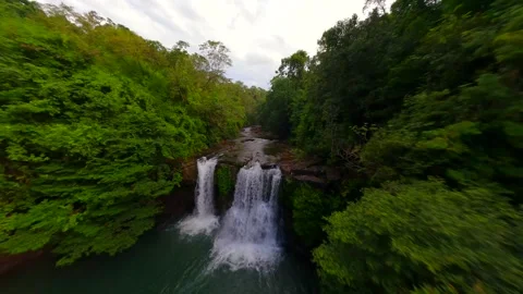 Cinematic FPV drone flight over tropical waterfall in lush jungle in Thailand Stock Footage 306516804