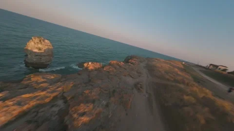 Cinematic FPV drone flight past natural rock arch at Tyulenovo, Bulgaria. Stock Footage 342224740