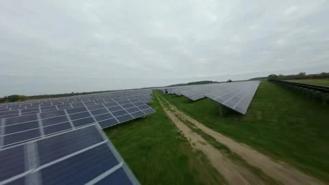 Cinematic FPV Drone View Flying Close Over Solar Panel Rows Renewable Energy Stock-Footage 323319301