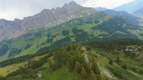 Cinematic FPV Flight Over Alpine Forest and Dramatic Mountain Valley 스톡 동영상 343944079