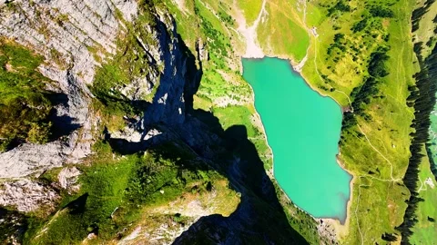 Cinematic FPV Flight Over Alpine Lake and Rocky Ridge in Switzerland Stock Footage 344532721