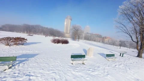 Cinematic FPV Flight Over Snowy Park Path — Winter Landscape Stock Footage 323247860