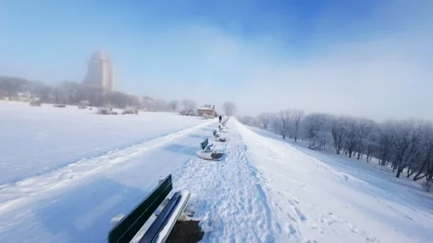 Cinematic FPV Flight Over Snowy Park Path — Winter Landscape Stock Footage 323248230