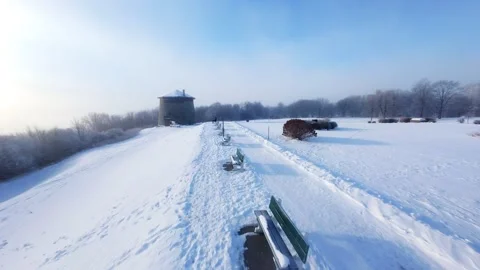 Cinematic FPV Flight Over Snowy Park Path — Winter Landscape Stock Footage 323248274