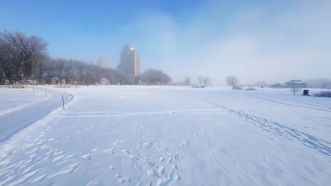 Cinematic FPV Flight Over Snowy Park Path — Winter Landscape Stock Footage 323248360