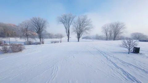 Cinematic FPV Flight Over Snowy Park Path — Winter Landscape Stock Footage 323248455