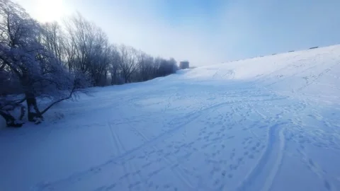 Cinematic FPV Flight Over Snowy Park Path — Winter Landscape Stock Footage 323248562