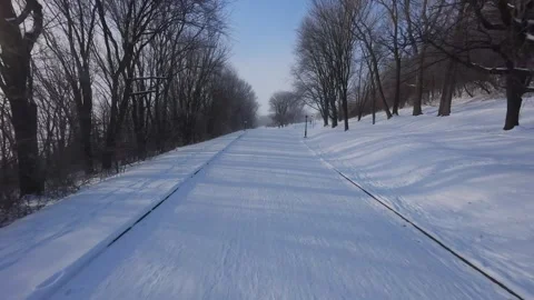 Cinematic FPV Flight Over Snowy Park Path — Winter Landscape Stock Footage 323248772