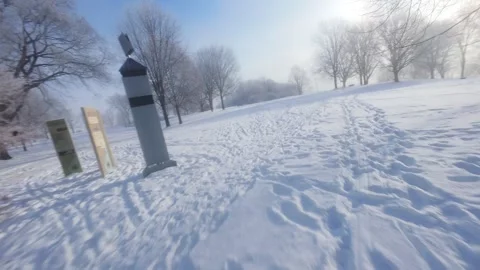 Cinematic FPV Flight Over Snowy Park Path — Winter Landscape Stock Footage 323249211