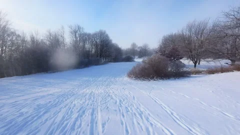 Cinematic FPV Flight Over Snowy Park Path — Winter Landscape Stock Footage 323249505