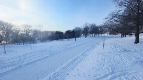 Cinematic FPV Flight Over Snowy Park Path — Winter Landscape Stock Footage 323249556