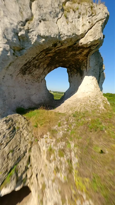 Cinematic FPV flight through a hole in the limestone rock Stock Footage 278606524