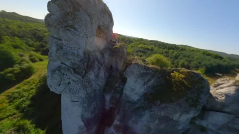 Cinematic FPV flight through a hole in the limestone rock Video stock 278606544