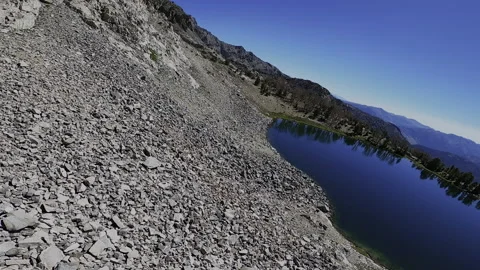 Cinematic FPV Mountain Dive: Talus Slope to Baptie Lake - Pioneer Mountains Stock Footage 331896984