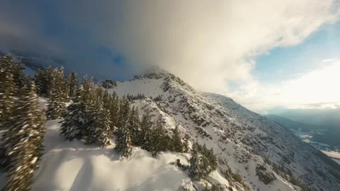 Cinematic FPV Shot Above Alpine Peak Covered in Snow Stock Footage 305801774