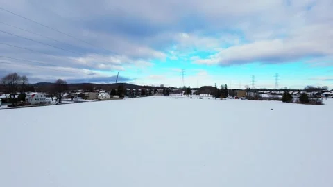 Cinematic fpv winter field flyover with lone tree and power lines Stock Footage 321380827