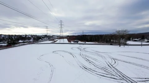 Cinematic fpv winter field flyover with lone tree and power lines Stock Footage 321380884