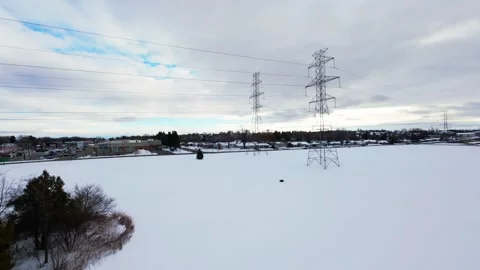 Cinematic fpv winter field flyover with lone tree and power lines Stock Footage 321380942