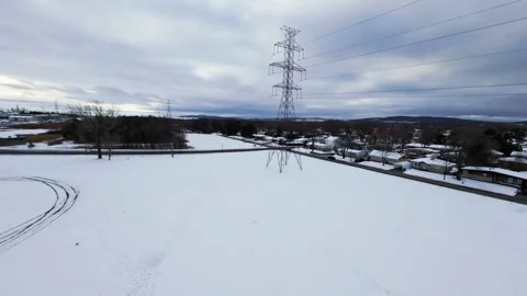 Cinematic fpv winter field flyover with lone tree and power lines Stock Footage 321380964