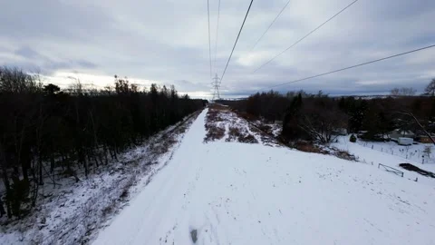 Cinematic fpv winter field flyover with lone tree and power lines Stock Footage 321380989
