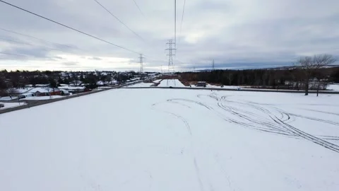 Cinematic fpv winter field flyover with lone tree and power lines Stock Footage 321381028