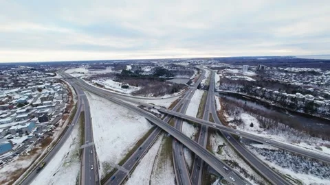 Cinematic fpv winter highway interchange — aerial city traffic view Stock Footage 321433995