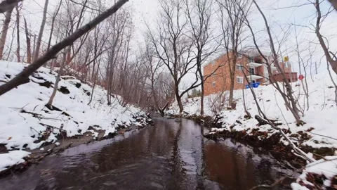 Cinematic fpv winter river low flythrough in snowy forest Stock Footage 321380009