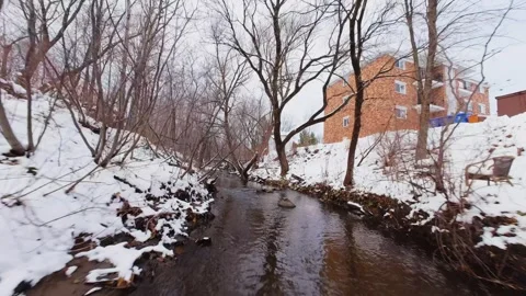 Cinematic fpv winter river low flythrough in snowy forest Stock Footage 321380218