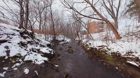 Cinematic fpv winter river low flythrough in snowy forest Stock Footage 321380370