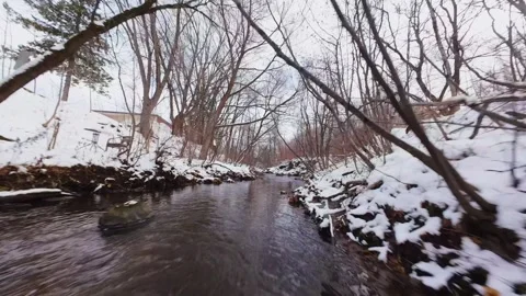 Cinematic fpv winter river low flythrough in snowy forest Stock Footage 321380510