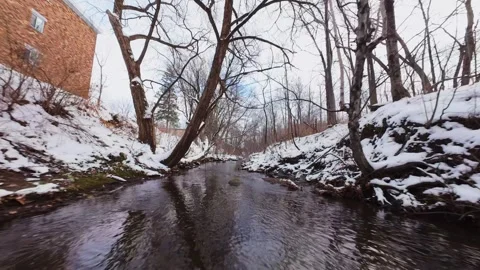 Cinematic fpv winter river low flythrough in snowy forest Stock Footage 321380582