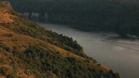 Cinematic frame. A motor boat sails on the wide river Dniester in Ukraine Video stock 246385836