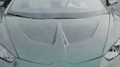 Cinematic front view of green supercar with carbon fiber hood Stock Footage 335076307
