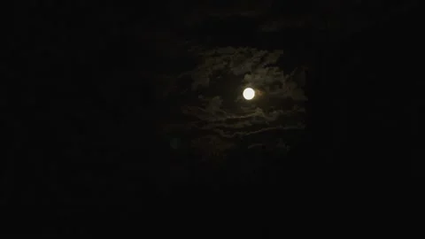 Cinematic full moon shining through dramatic dark clouds at night Stock Footage 335919052