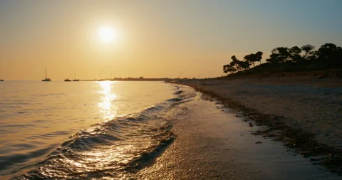 Cinematic Gimbal Flyover of Sandy Beach and Sea at Sunset, Slow Motion Stock Footage 343611876