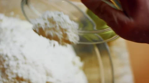 Cinematic gloved hand adding citrus zest to cream mixture in detail, 4K Stock Footage 341115879
