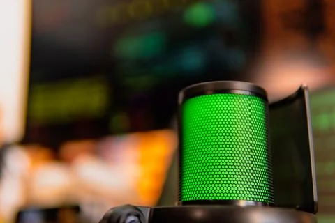 Cinematic hacker workspace with green code screens and microphone setup Stock Photos