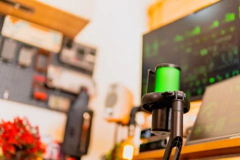 Cinematic hacker workspace with green code screens and microphone setup Stock Photos