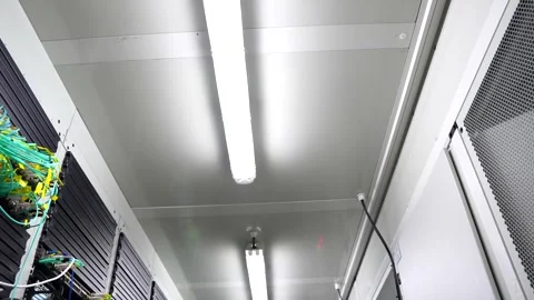 Cinematic Handheld Pan Down Server Cabinets with Network Cables in Modern D.. Video stock 341699698