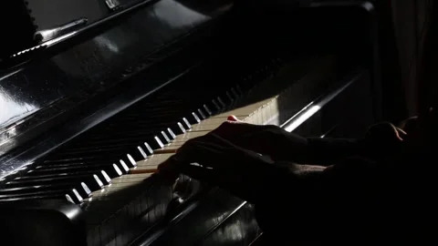 Cinematic hands playing the piano on a dramatic dark stage Video stock 241492945
