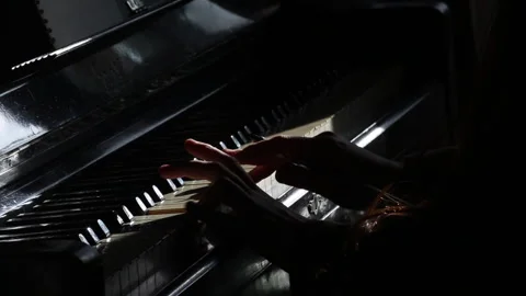 Cinematic hands playing the piano on a dramatic dark stage Stock Footage 242804918
