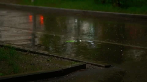 Cinematic heavy rain falling on a wet city road 库存影片 341536254